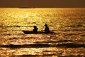 silhouette ofÃÂ Boatman rowing in the golden sea